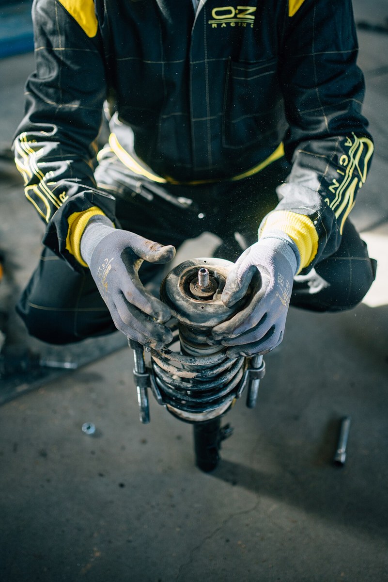 Mechanic holding an automotive suspension strut