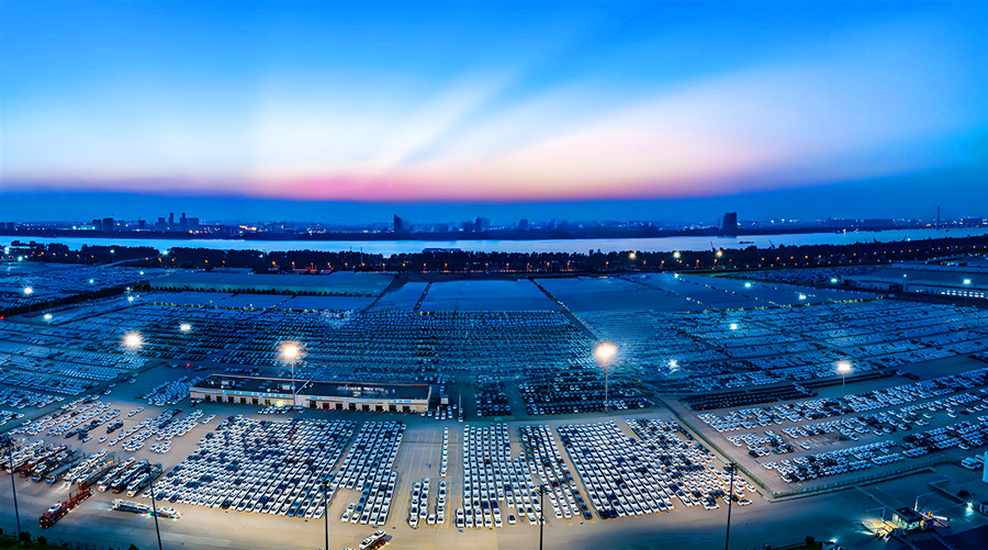 Blue-hour aerial view of rows of vehicles in Wuhan Jingang Automotive Industrial Park